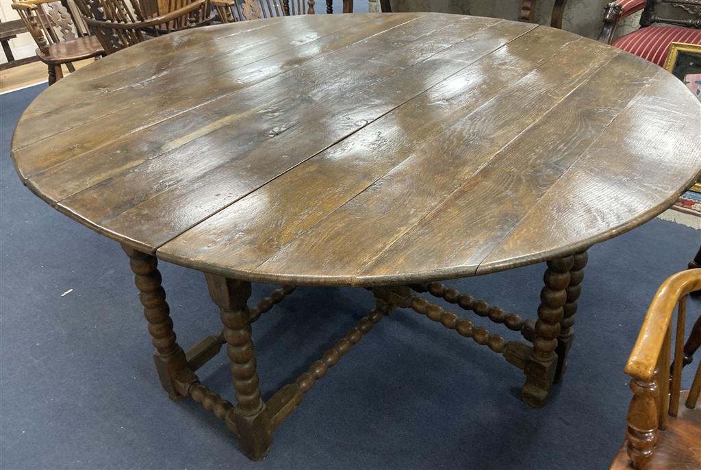 An 18th century and later oak bobbin leg gateleg dining table, length 170cm extended, width 162cm, height 76cm